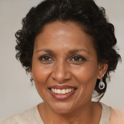 Joyful black adult female with medium  brown hair and brown eyes