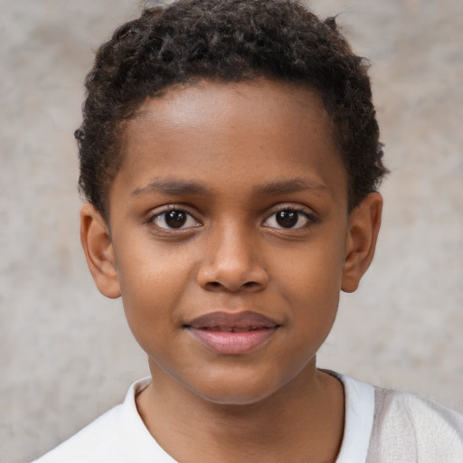 Joyful black child male with short  brown hair and brown eyes