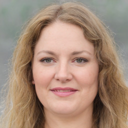 Joyful white young-adult female with medium  brown hair and green eyes