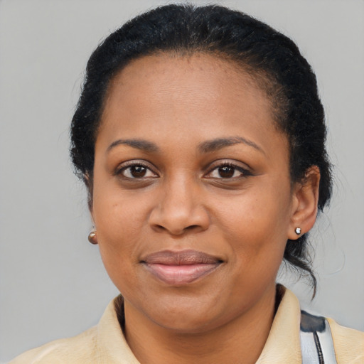 Joyful black adult female with short  black hair and brown eyes
