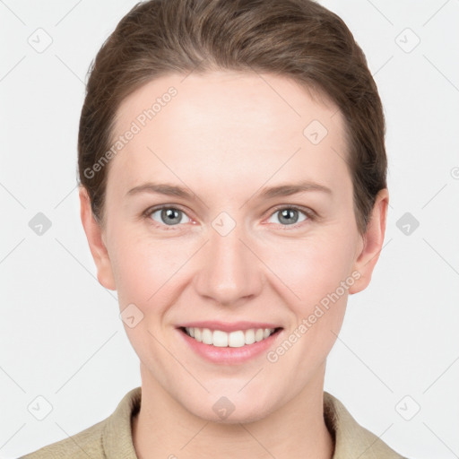 Joyful white young-adult female with short  brown hair and grey eyes