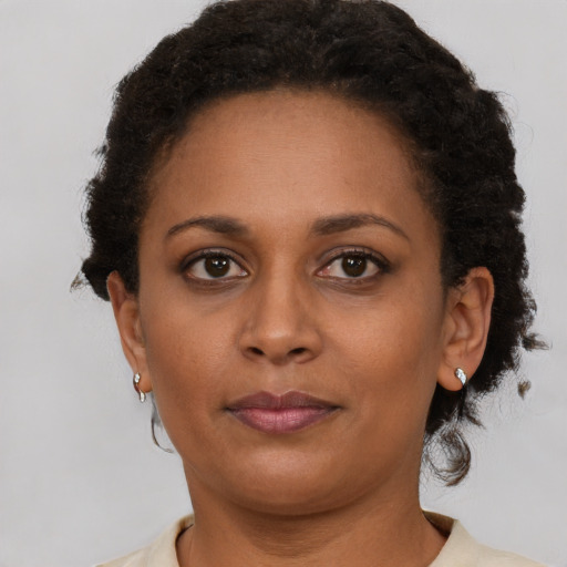 Neutral black adult female with short  brown hair and brown eyes