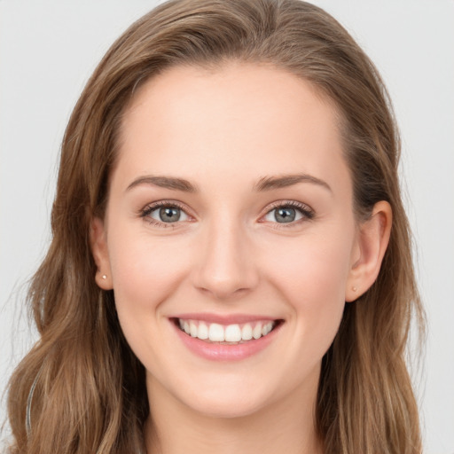 Joyful white young-adult female with long  brown hair and blue eyes