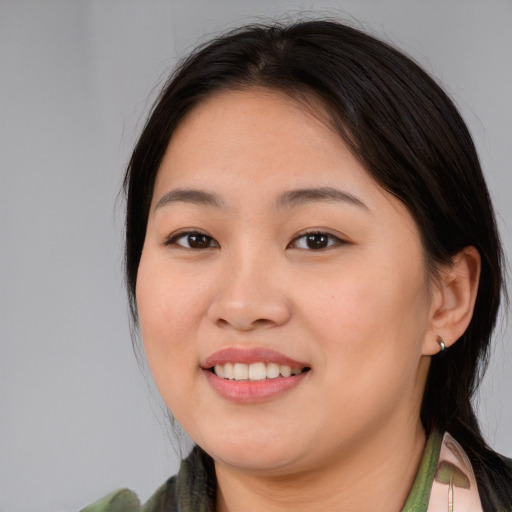 Joyful asian young-adult female with medium  brown hair and brown eyes