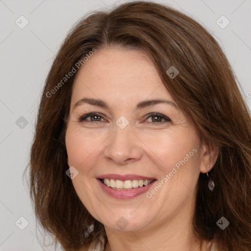 Joyful white adult female with long  brown hair and brown eyes