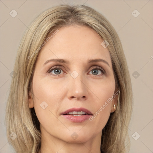 Joyful white adult female with long  brown hair and grey eyes