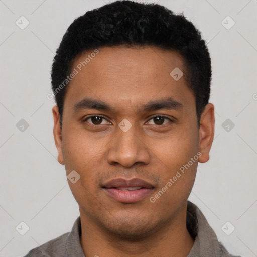 Joyful black young-adult male with short  black hair and brown eyes