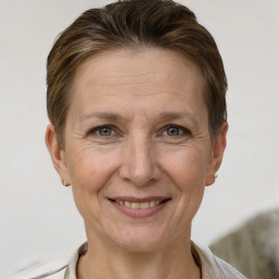 Joyful white adult female with short  brown hair and grey eyes