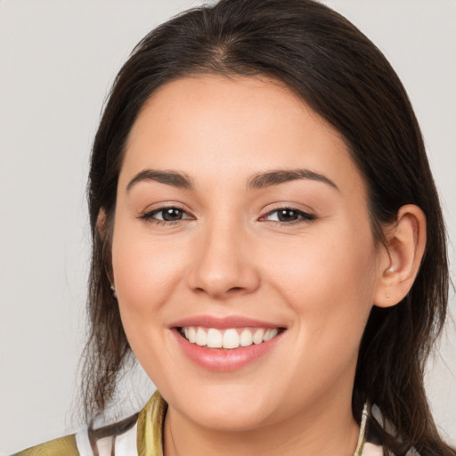 Joyful white young-adult female with medium  brown hair and brown eyes