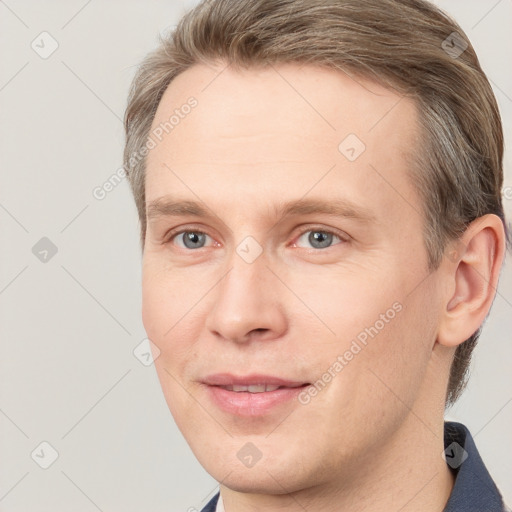 Joyful white young-adult male with short  brown hair and grey eyes