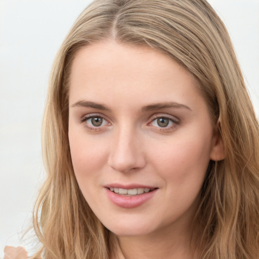 Joyful white young-adult female with long  brown hair and blue eyes