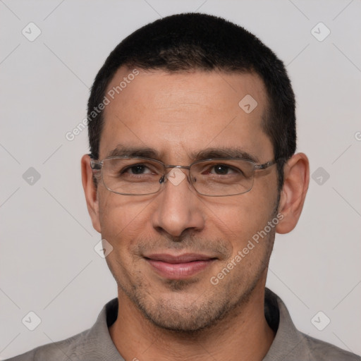 Joyful white adult male with short  black hair and brown eyes