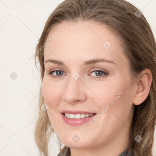 Joyful white young-adult female with long  brown hair and grey eyes