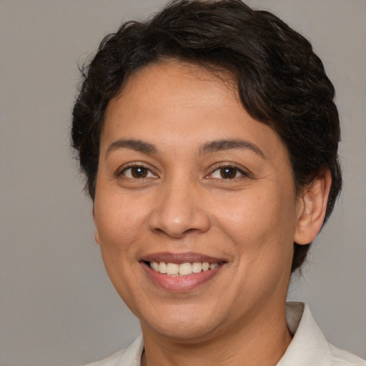 Joyful white adult female with medium  brown hair and brown eyes
