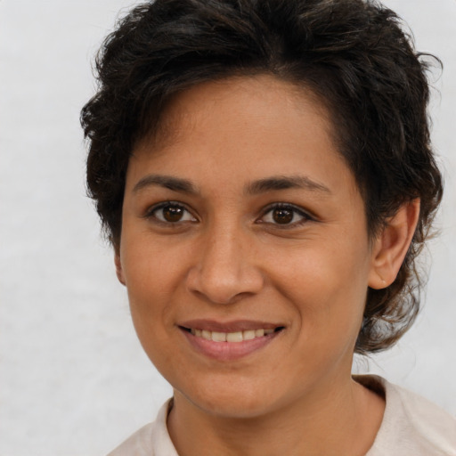 Joyful latino young-adult female with short  brown hair and brown eyes