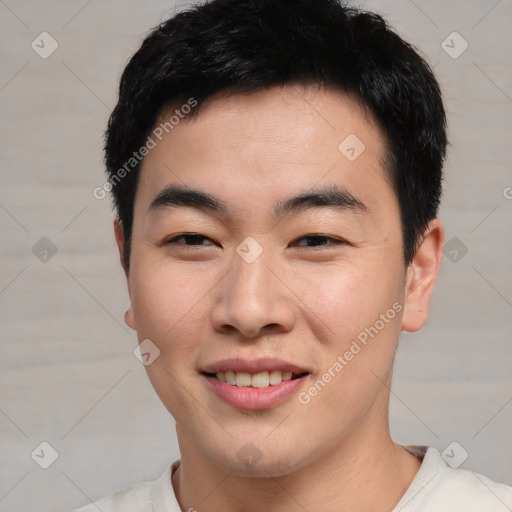 Joyful asian young-adult male with short  black hair and brown eyes