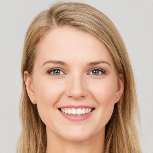 Joyful white young-adult female with long  brown hair and grey eyes