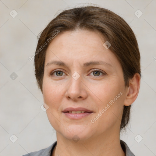 Joyful white adult female with medium  brown hair and grey eyes