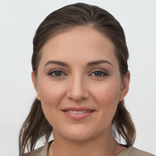 Joyful white young-adult female with long  brown hair and grey eyes