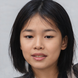 Joyful asian young-adult female with medium  black hair and brown eyes