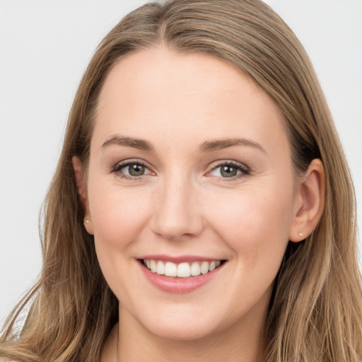 Joyful white young-adult female with long  brown hair and grey eyes