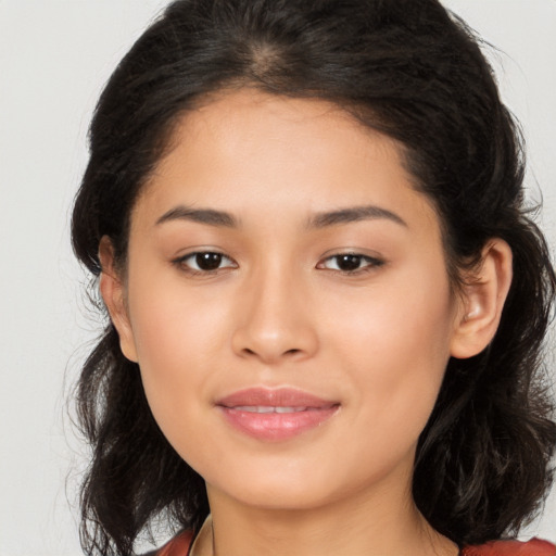 Joyful latino young-adult female with medium  brown hair and brown eyes