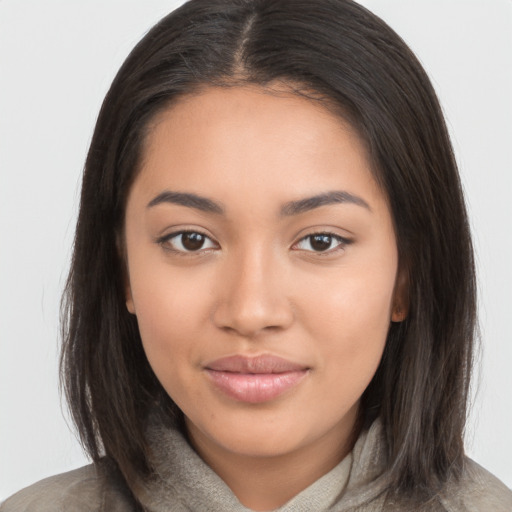 Joyful latino young-adult female with medium  brown hair and brown eyes