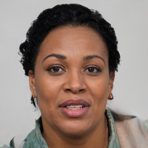 Joyful black adult female with short  black hair and brown eyes