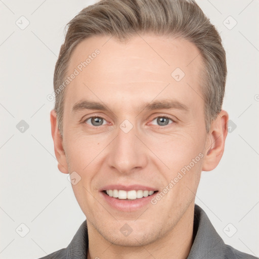 Joyful white young-adult male with short  brown hair and grey eyes