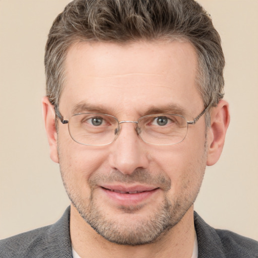 Joyful white adult male with short  brown hair and grey eyes