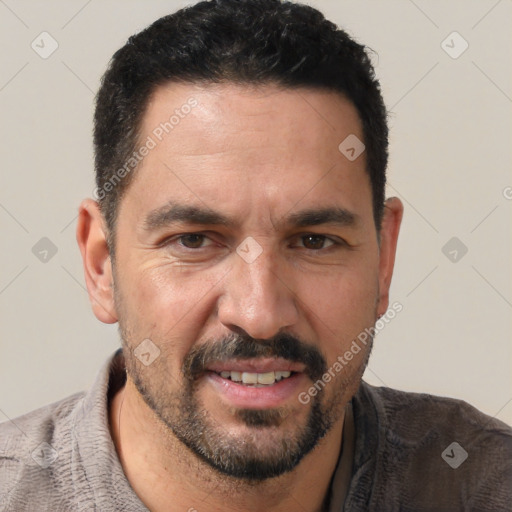 Joyful white adult male with short  black hair and brown eyes