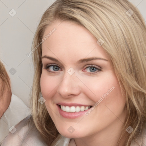 Joyful white young-adult female with long  brown hair and blue eyes