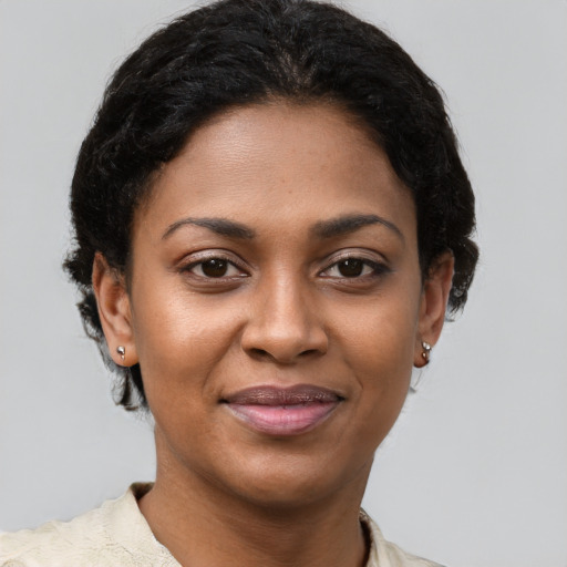 Joyful black young-adult female with short  brown hair and brown eyes