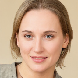 Joyful white young-adult female with medium  brown hair and blue eyes