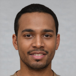 Joyful latino young-adult male with short  brown hair and brown eyes