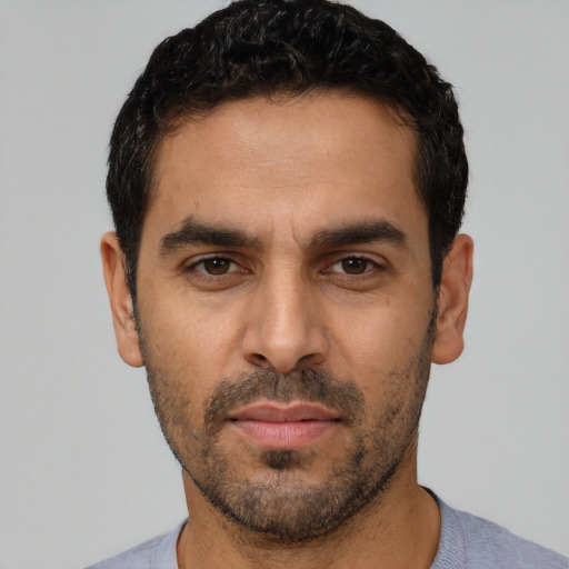 Neutral latino young-adult male with short  black hair and brown eyes