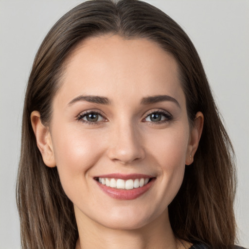 Joyful white young-adult female with long  brown hair and grey eyes