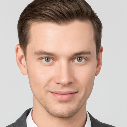 Joyful white young-adult male with short  brown hair and grey eyes