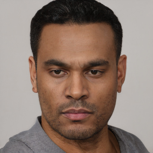 Neutral latino young-adult male with short  black hair and brown eyes