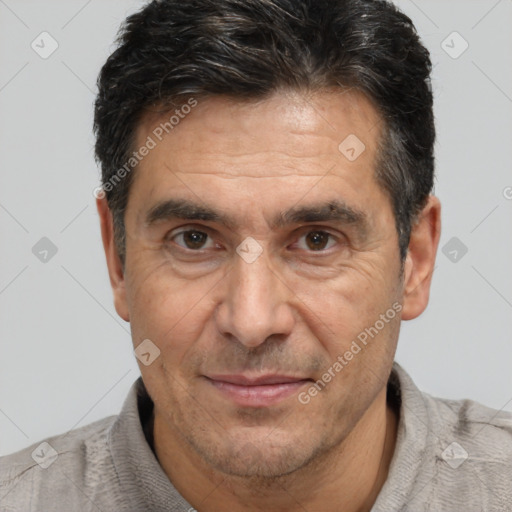 Joyful white adult male with short  black hair and brown eyes