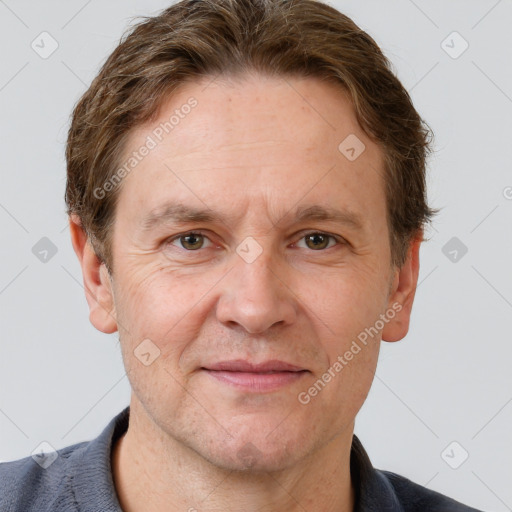 Joyful white adult male with short  brown hair and grey eyes