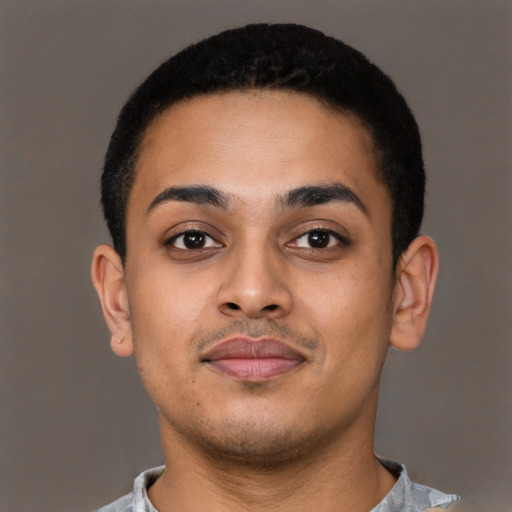 Joyful latino young-adult male with short  brown hair and brown eyes