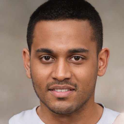 Joyful black young-adult male with short  brown hair and brown eyes