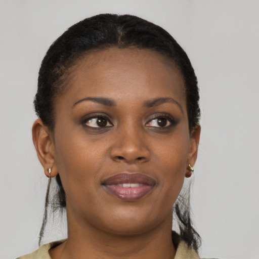 Joyful black young-adult female with short  brown hair and brown eyes
