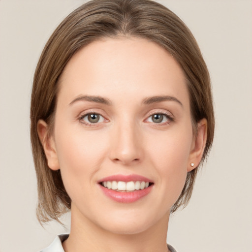 Joyful white young-adult female with medium  brown hair and green eyes