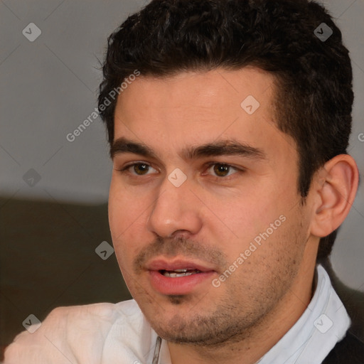 Joyful white young-adult male with short  black hair and brown eyes