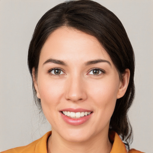 Joyful white young-adult female with medium  brown hair and brown eyes