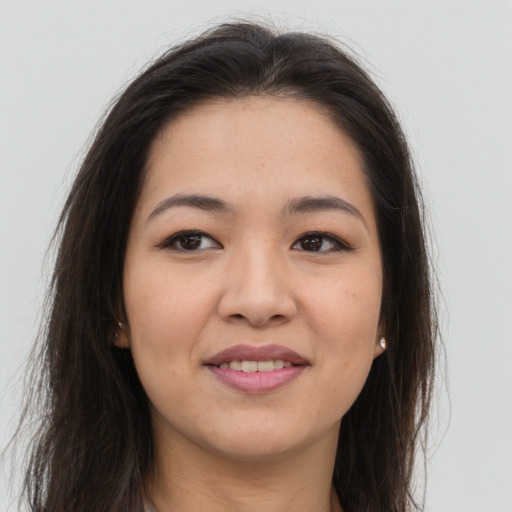 Joyful asian young-adult female with long  brown hair and brown eyes