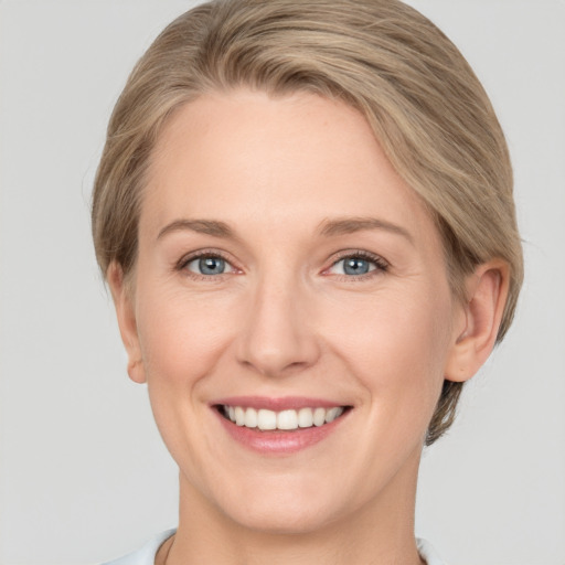 Joyful white adult female with short  brown hair and grey eyes