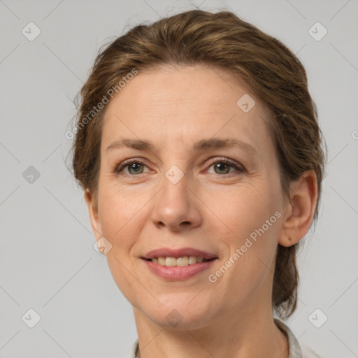 Joyful white adult female with medium  brown hair and grey eyes